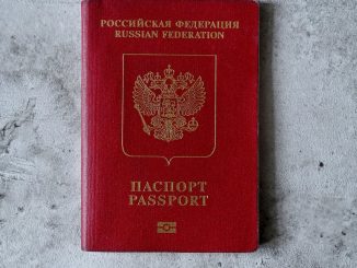 overhead shot of a russian passport on a cement surface